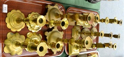 Lot 614 - Two trays of English 18th century brass candlesticks of assorted sizes