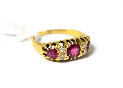 Lot 628 - A ruby and diamond ring, the graduated round rubies spaced by pairs of old cut and brilliant...