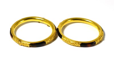 Lot 638 - A pair of late 19th/early 20th century Chinese gold and tortoise shell bangles by Wang Hing,...