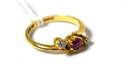 Lot 643 - An 18 carat gold ruby and diamond three stone twist ring, in yellow claw settings two knife...