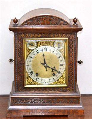 Lot 657 - A quarter striking table clock, circa 1890, arched case, side sound fret doors, brass dial with...