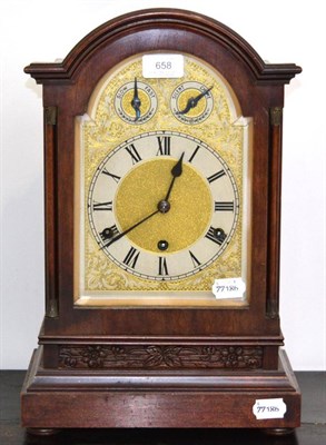 Lot 658 - A mahogany chiming table clock, circa 1910, arched case, side sound frets, silvered Roman...