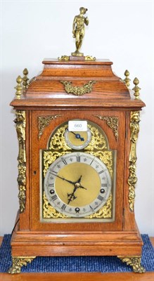 Lot 660 - An oak chiming table clock, circa 1890, caddied top, gilt metal mounts, side sound frets and...