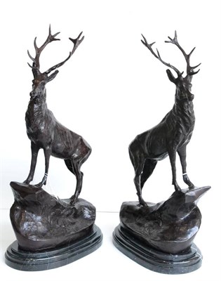 Lot 668 - A pair of reproduction bronzed figures of stags, on grey marble bases, 71cm high