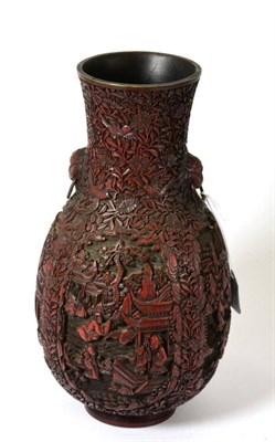 Lot 694 - A Chinese cinnabar lacquer vase, Qing Dynasty, of ovoid form, the flared neck with mask...