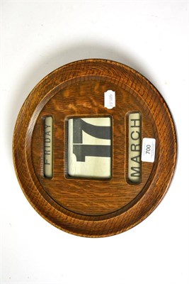 Lot 700 - A 1920s/1930s oak wall calendar, 30cm diameter