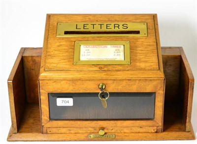 Lot 704 - A late Victorian/Edwardian oak and brass mounted 'Country House' post box label stamped inside J.C.