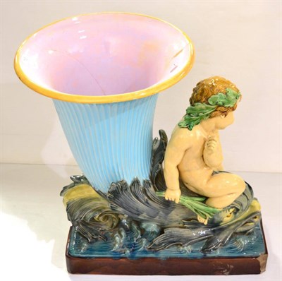 Lot 707 - A large Minton majolica vase in the form of a putto on a dolphin cornucopia, 71cm high (a.f.)