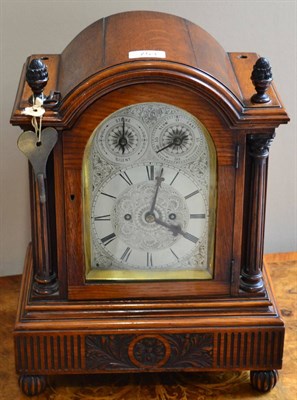 Lot 753 - An oak striking table clock, circa 1890, arched case with acorn finials, side sound frets, silvered