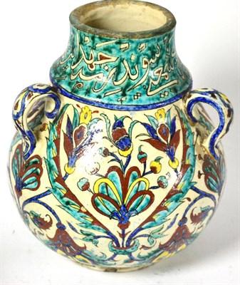 Lot 761 - A 19th century Iznik vase with three loop handles and hollow base, height 21cm