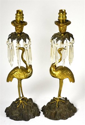 Lot 777 - A pair of William IV parcel gilt bronze figural candlesticks, each modelled as a flamingo with...