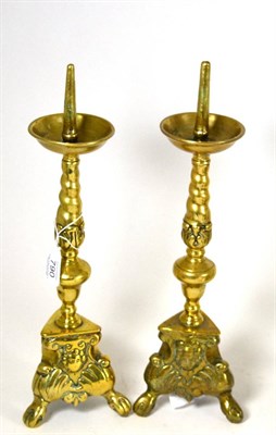 Lot 790 - A pair of Flemish brass pricket candlesticks, 18th century, the circular drip pans on foliate...