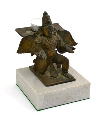 Lot 793 - An Indian bronze modelled as a Winged Buddha kneeling riased on a modern grey marble base,...