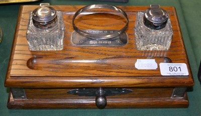 Lot 801 - A oak desk two bottle inkwell standish with silver mounts