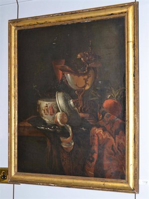 Lot 1052 - After Willem Kalf (1679-1693) Dutch, A still life of a mounted nautilus shell, an oriental...