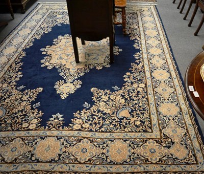 Lot 1220 - Kirman carpet, South East Persia, the deep indigo field centred by a pole medallion, the...