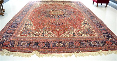 Lot 1233 - Heriz carpet, Persian Azerbaijan, the terracotta field of angular vines around an indigo pole...