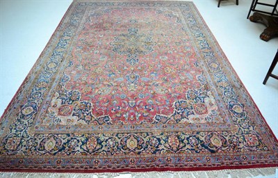 Lot 1236 - Kashan carpet, Central Persia, the faded raspberry field of palmettes and vines around a...