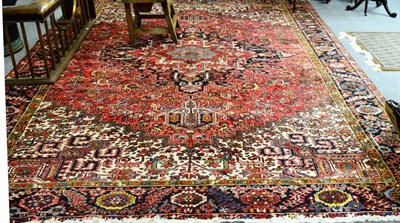 Lot 1242 - Heriz carpet, Persian Azerbaijan, the faded crimson field of angular vines around an indigo...