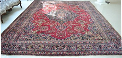 Lot 1249 - Mashad carpet, North East Persia, the crimson field of floral design centred by an indigo pole...