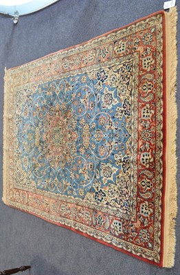 Lot 1250 - Isfahan rug, Central Persia, the ice blue field of scrolling vines around a flowerhead...