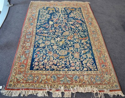 Lot 1251 - Ghom part silk rug, Central Persia, the mid indigo field with ";Tree of Life"; and birds...