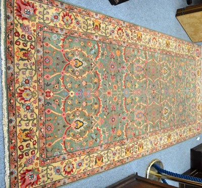 Lot 1255 - An unusual rug of Oriental design, the mint green field with an allover design of serrated...