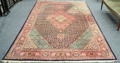 Lot 1265 - Tabriz carpet, Persian Azerbaijan, the indigo Herati field centred by a coral pink medallion framed