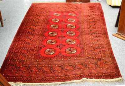 Lot 1267 - Turkman rug, North Afghanistan, the madder field with two columns of quartered guls enclosed by...