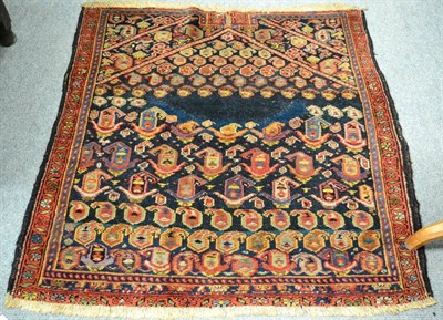 Lot 1269 - Rare Khomseh saddle rug, South West Persia, the deep indigo field of boteh beneath an arch...