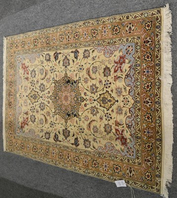 Lot 1270 - A good Tabriz part silk rug, the ivory field of scrolling vines around a medallion, framed by...