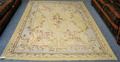 Lot 1271 - An 'Aubusson' carpet, China, the pale cream ground centred by a panel with a floral spray framed by