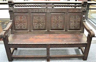 Lot 1307 - + Carved oak settle, with initials T B A and dated 1655, above four fielded panels