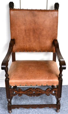 Lot 1319 - A pair of ebony and leather seated armchairs with lion mask caps