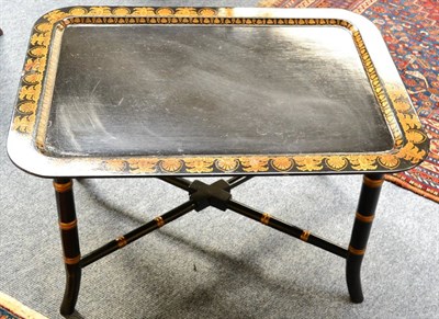 Lot 1332 - A pair of ebonised tray top tables in the Regency style