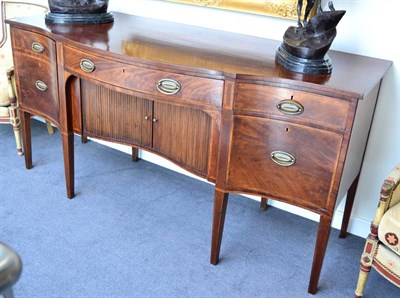 Lot 1333 - A George III mahogany serpentine fronted sideboard