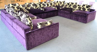 Lot 1337 - Large corner sofa upholstered in purple velvet with scatter cushion, 450cm wide