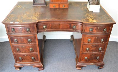 Lot 1348 - A mahogany pedestal desk with bow ends, indented panels to sides, original leather top, ogee...