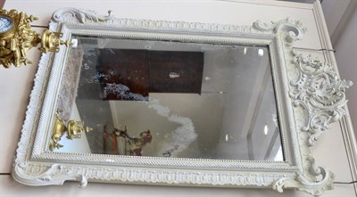 Lot 1387 - A 19th century Rococo style wall mirror, later cream painted and with original distressed...