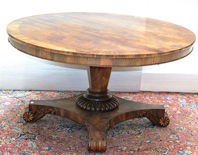 Lot 1398 - A Regency rosewood dining table, the circular top raised on a tapered hexagonal pillar with...