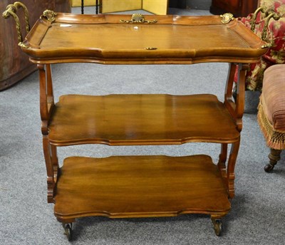 Lot 1417 - * A walnut and brass mounted three-tier serving trolley