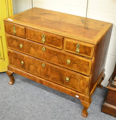 Lot 1419 - An 18th century walnut and crossbanded five drawer straight fronted chest, the top quarter veneered