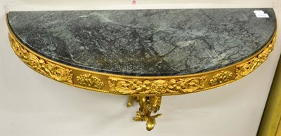 Lot 1422 - * A gilt metal D-shaped bracket/console with green marble top, 82cm wide