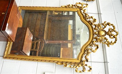 Lot 1427 - A gilt framed mirror, in the Régence style, the arched plated within a ribbon-carved frame...