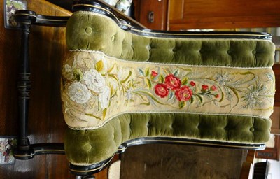 Lot 1441 - A late Victorian ebonised nursing chair with original floral needlework fabric