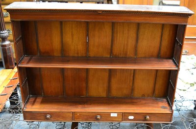 Lot 1442 - A George III style mahogany wall shelf with three base drawers