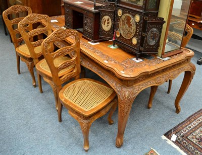 Lot 1448 - A carved cherrywood dining table and six chairs in the French style