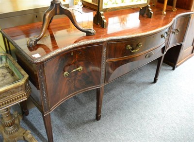 Lot 1451 - A George III mahogany serpentine fronted sideboard