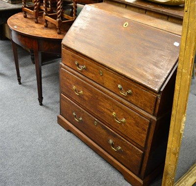 Lot 1461 - + An 18th century oak bureau and a George III mahogany demi-lune table