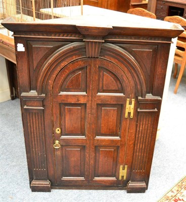 Lot 1465 - An oak floor standing corner cupboard of architectural design